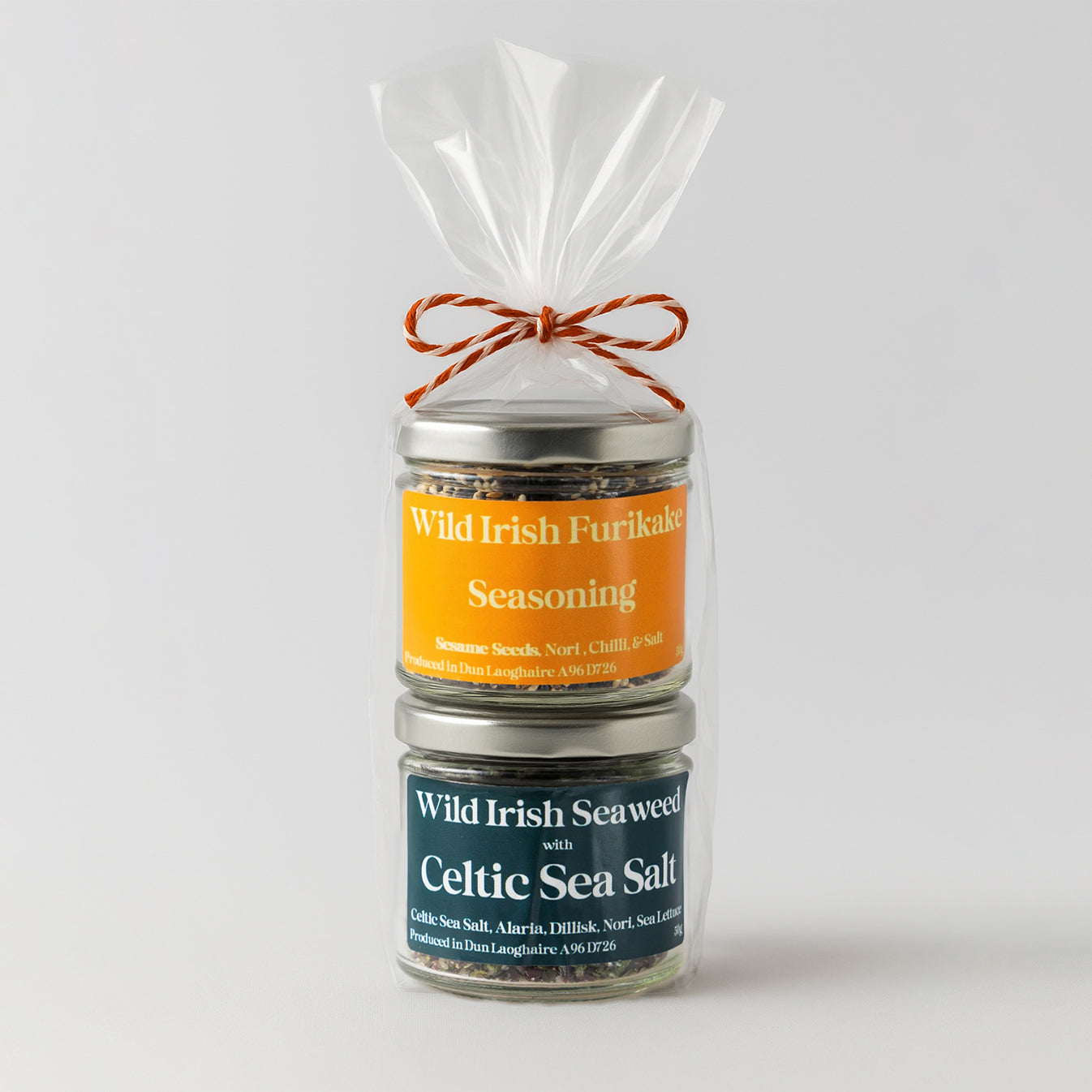 A Jar of Wild Irish Sea Weed with Celtic Sea Salt and a Jar of Wild Irish Furikake Seasoning gift wrapped with a bow on a white background