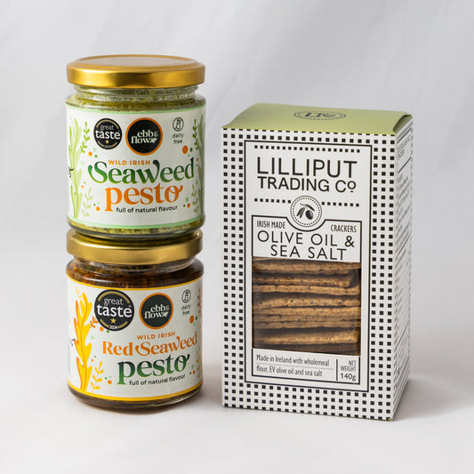 Two jars of Seaweed Pesto (one green and one red) and a box of Lilliput Olive Oil & Sea Salt crackers on a white background