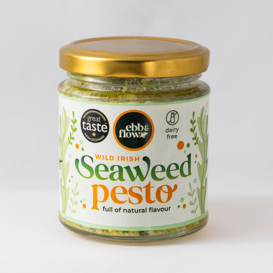 Jar of wild Irish seaweed green pesto with a gold lid on a white background