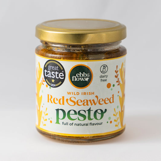 Jar of wild Irish seaweed red pesto with a gold lid on a white background